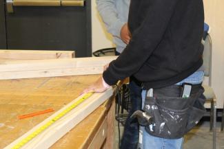Students learning basic woodworking skills to prepare for a career as carpenters. 
